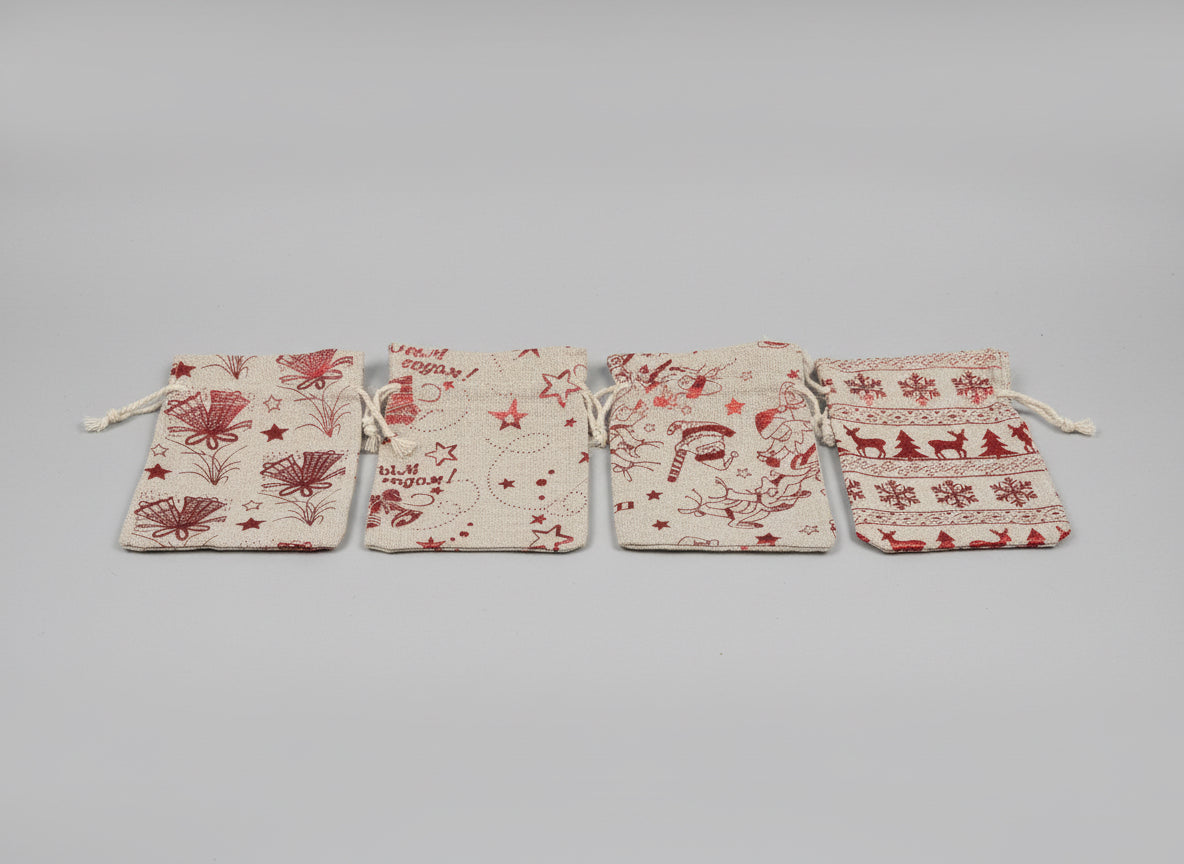 Four fabric pouches with different patterns on a desk next to a laptop.