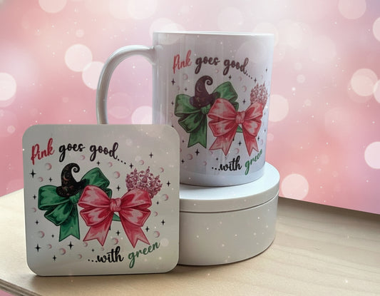 Mug and coaster set with decorative designs on a wooden surface.