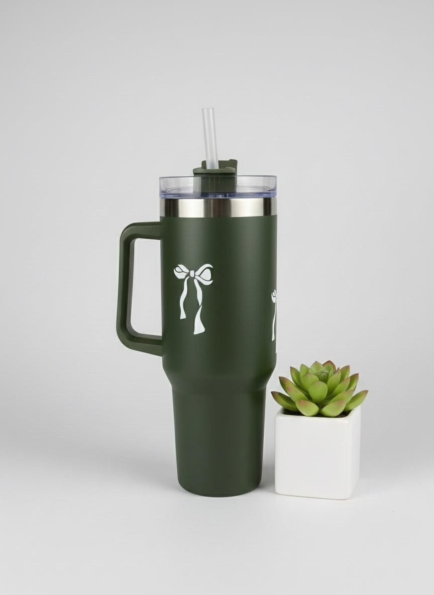 Green insulated tumbler with handle on a light surface