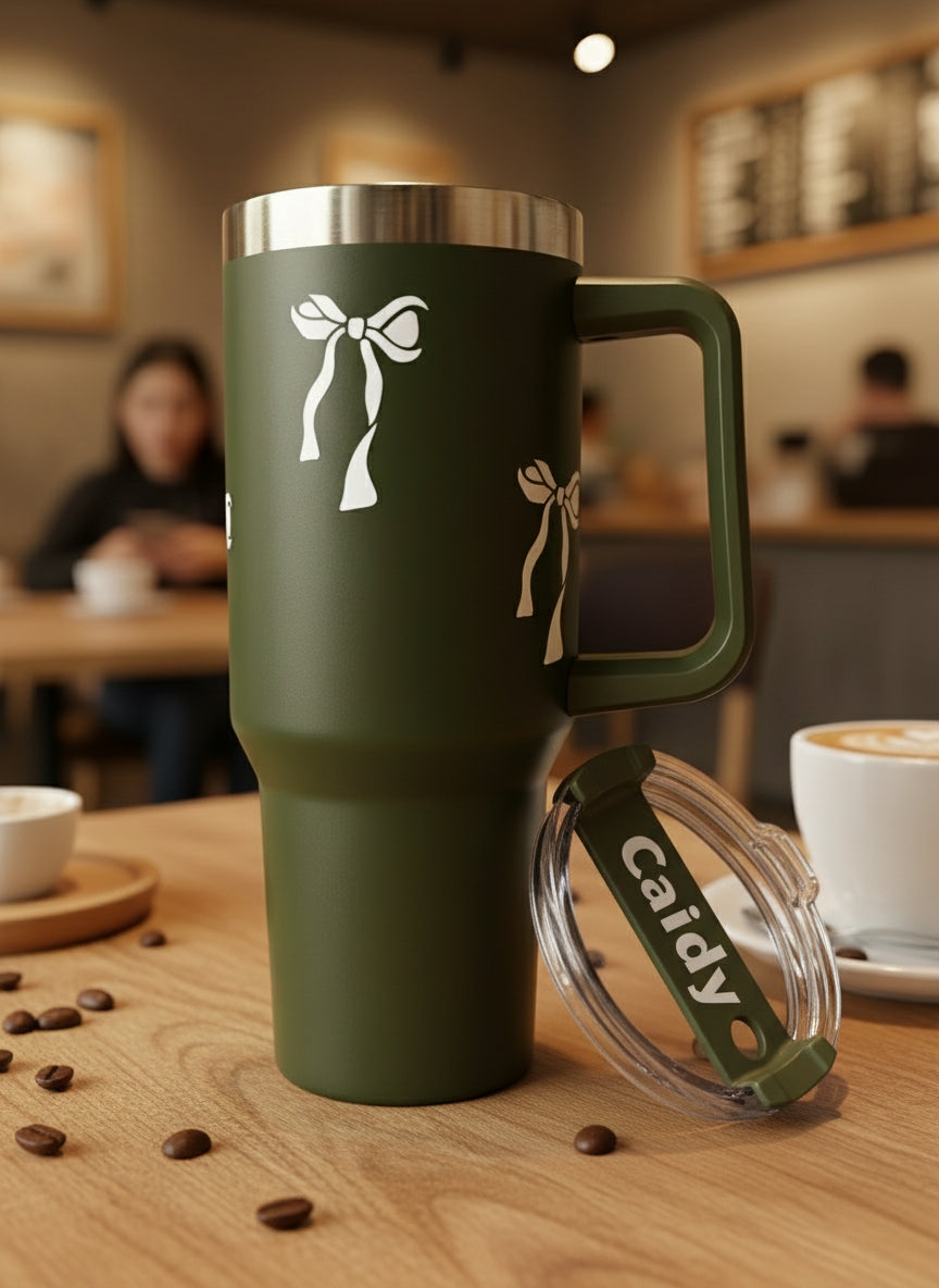 GREEN insulated tumbler with floral design and 'Candy' label on a light surface.
