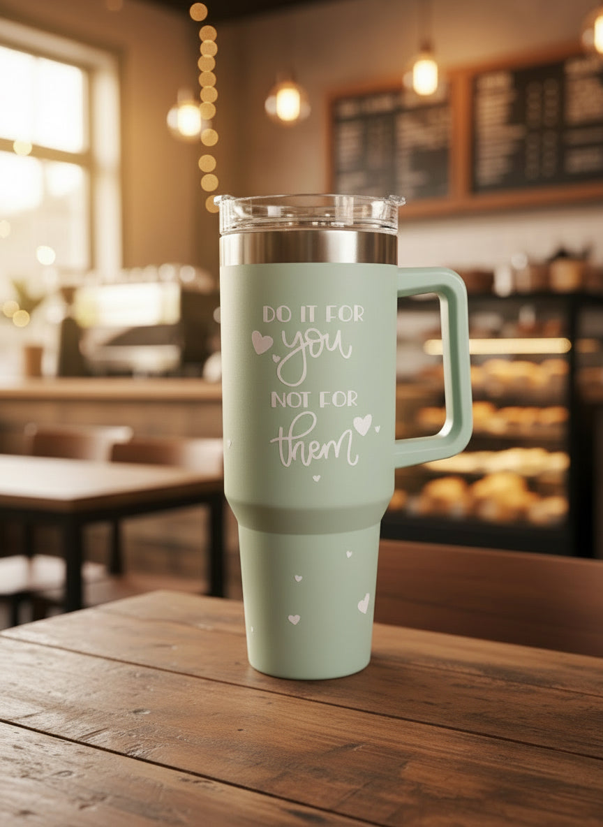 Green thermos with motivational quote on a light background