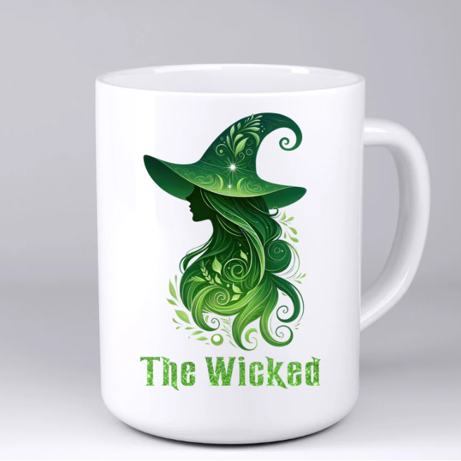 White mug with green witch design and 'The Wicked' text on a white background